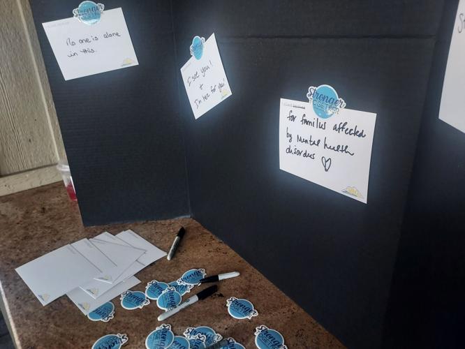 Community members participate in Climb Out of the Darkness support board