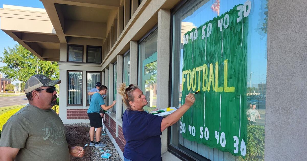 MHS Huddle painting windows for first Mattoon home football game of the season MHS Huddle painting windows for first Mattoon home football game of the season