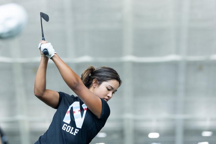 Northwestern Wildcats' Lauren E. Lee prepares her swing during a Northwestern women’ s golf practice at Ryan Fieldhouse in Evanston, Illinois, on Friday, Feb. 20, 2026.