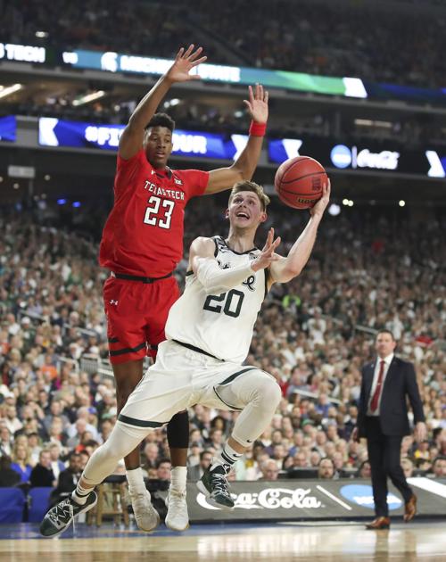 Michigan State's Matt McQuaid (20) shoots under Texas Tech's Jarrett Culver (23) during the first half in a semifinal of the NCAA Tournament Final Four on Saturday, April 6, 2019, at U.S. Bank Stadium in Minneapolis.
