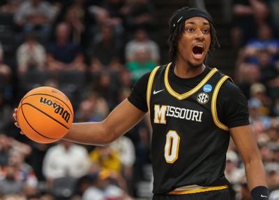 Mizzou guard Anthony Robinson II (0) dribbles and calls out (copy)