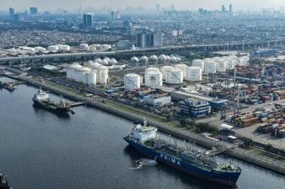 Tankers and cargo ships at the oil depot and container terminal of the Tanjung Priok Port in Jakarta