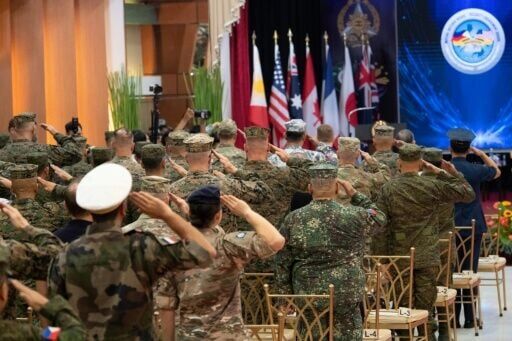 Philippine and US soldiers salute as their national anthems are played during the opening ceremony of the annual Balikatan military exercise at Camp Aguinaldo in Manila on Monday