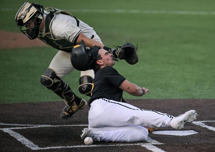 Mizzou catcher Mateo Serna collides with the outstretched glove of Vanderbilt catcher Korbin Reynolds