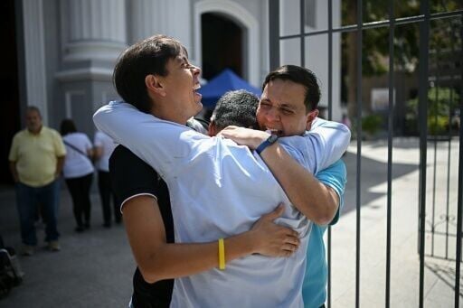 Venezuelan human rights activist Javier Tarazona (right) reunites with his brother Jose Rafael Tarazona (left) and lawyer Omar de Dios Garcia after his release from prison