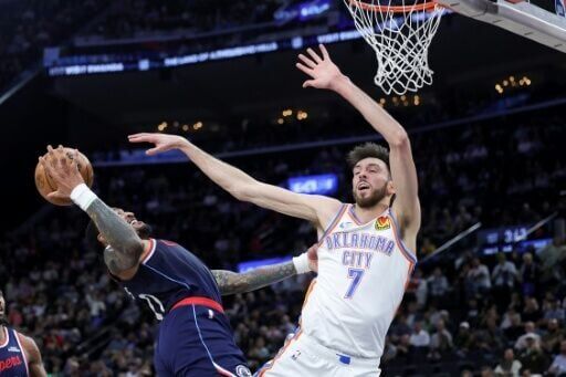 Oklahoma City center Chet Holmgren and John Collins of the Los Angeles Clippers vie for the ball in the Thunder's NBA victory at Intuit Dome