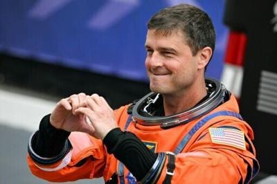 NASA astronaut Reid Wiseman gestured a heart sign before the Artemis II took off to orbit the Moon, where a crater was named "Carroll" in honor of his deceased wife