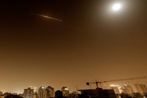 Rocket trails are seen in the sky above the Netanya, Israel