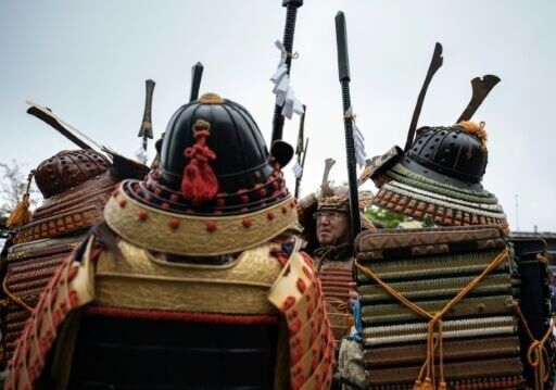 At dawn, people dressed as armoured samurai warriors join the Shinto priests on a kilometre-long climb back to the summit shrine