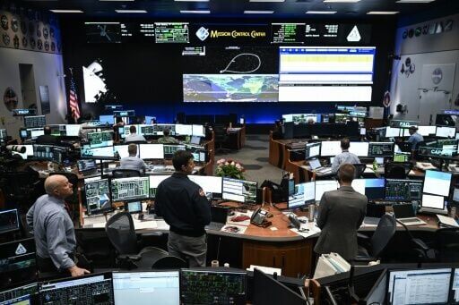 Engineers and technicians monitor the Artemis 2 mission from the Lyndon B Johnson Space Center in Houston