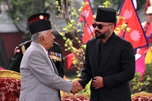 Nepal's newly sworn-in prime minister Balendra Shah (R) shakes hands with president Ram Chandra Paudel (L) during a swearing-in ceremony in Kathmandu on March 27, 2026.