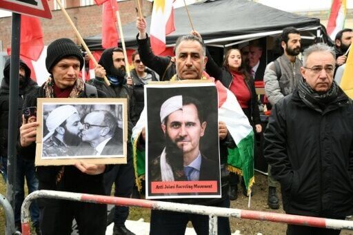 People protest against the visit of Syrian President Ahmed al-Sharaa in front of the German Foreign Ministry