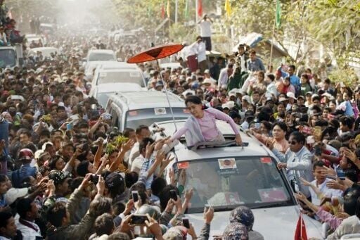 Aung San Suu Kyi -- then Myanmar's opposition leader -- greets supporters during her father's 100th birthday celebration in February 2015