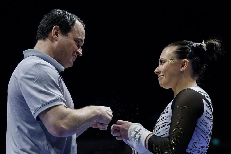 Mizzou gymnastics head coach Shannon Welker fist bumps Lauren Macpherson