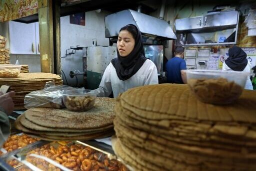 An Iranian woman works at a bakery in Tehran