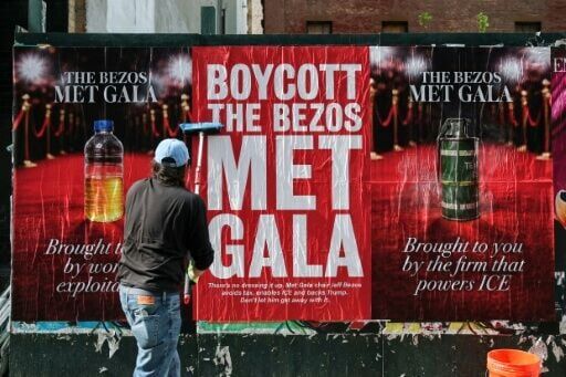 A person puts up 'Boycott the Bezos Met Gala' posters in New York City on April 15, 2026