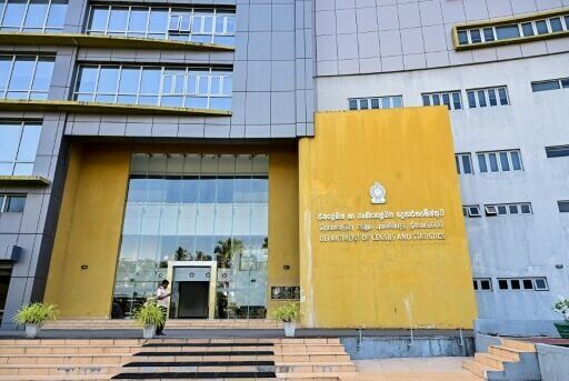 A security guard stands outside the closed Department of Census and Statistics building in Colombo on March 25, 2026 after Sri Lanka introduced a four-day work week to conserve fuel reserves during the Middle East war.