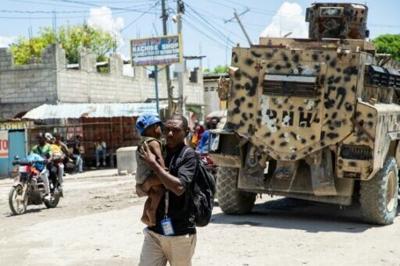 Residents flee a neighborhood after gang violence in Port-au-Prince, Haiti, on April 20, 2026