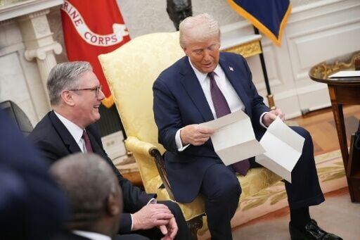 US President Donald Trump reads a letter from King Charles III given to him by British Prime Minister Keir Starmer inviting him to visit Britain in 2025