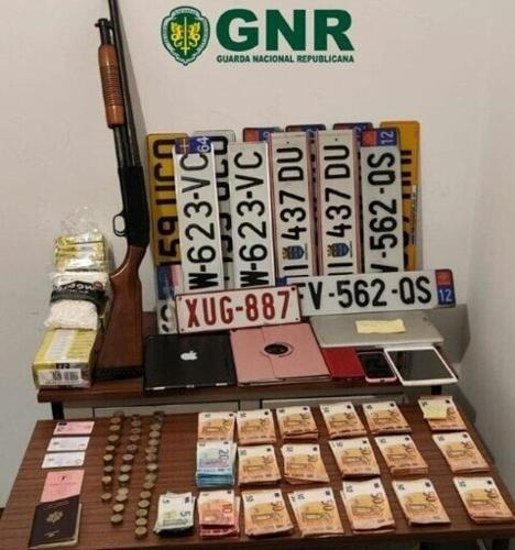 A photo released by Portuguese police showing the gun, fake number plates and cash found in the suspect's car