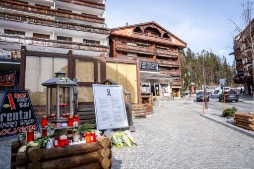 Candles and flowers left by Le Constellation bar in Crans-Montana