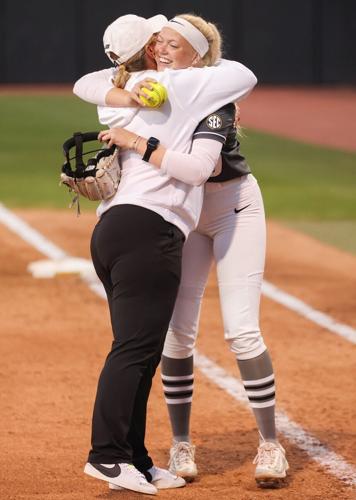 From left, Mizzou softball head coach Larissa Anderson embraces Marissa McCann (10)