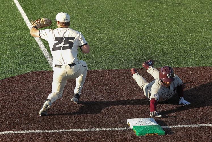 Texas A&M outfielder Jake Duer (3), right, slides back to first base