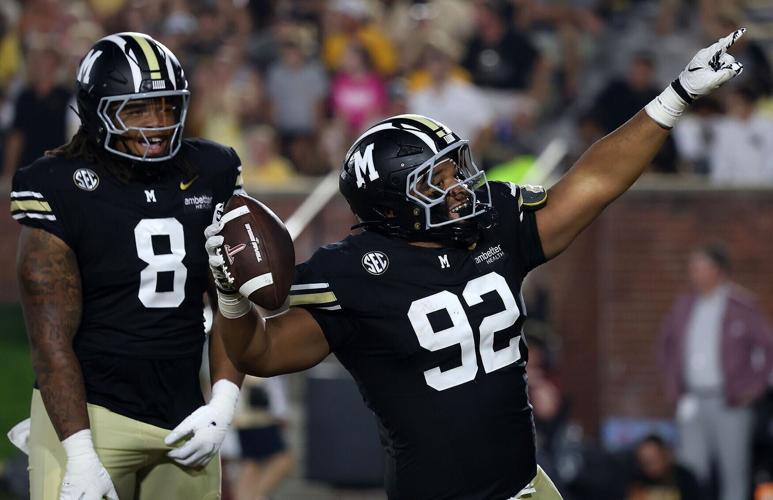 Mizzou nose tackle Jason Dowell (92) celebrates after recovering a fumble
