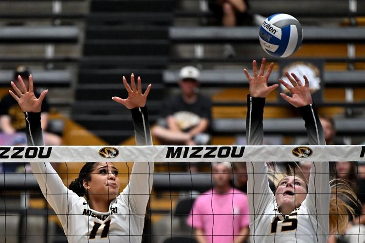 Mizzou freshman middle blocker Eva Smith (11) and sophomore outside hitter Paige Felder (15) go to block a hit