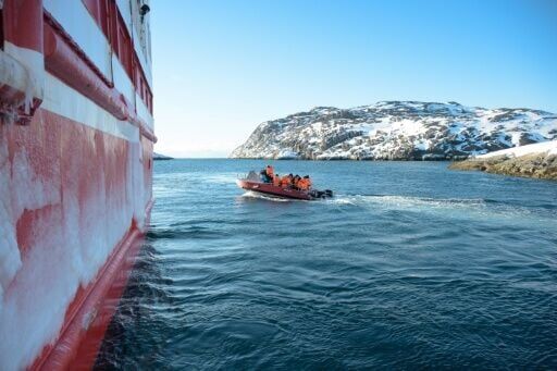 Passengers take a small motorboat from the ferry to reach the village of Kangaamiut, Greenland