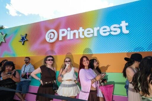 Festival-goers line up to get inside the activation booth of US social media service Pinterest during the 2026 Coachella Valley Music and Arts Festival