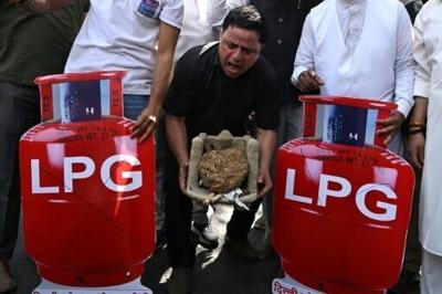 Soaring black market prices of cooking gas in India's capital are pushing poorer families back to wood and coal