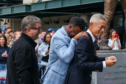 Ichiro Suzuki, Edgar Martinez and Ken Griffey Jr. see the funny side after a statue honoring Suzuki was damaged during an unveiling ceremony