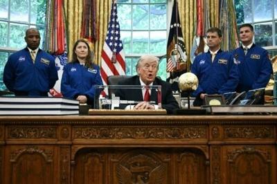 US President Donald Trump speaks as he welcomes the Artemis II astronauts, from L to R, Victor Glover, Christina Koch, Reid Wiseman and Jeremy Hansen in the Oval Office at the White House in Washington, DC, on April 29, 2026