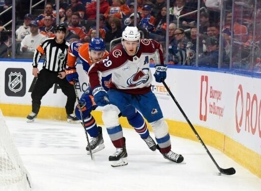 Canadian forward Nathan MacKinnon of the Colorado Avalanche carries the puck ahead of compatriot Connor McDavid of the Edmonton Oilers during an NHL game, but the stars will be teammates at the Winter Olympics