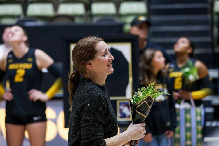 Mizzou head coach Dawn Sullivan holds flowers and welcomes senior players to the court for Senior Night