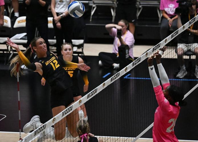 Mizzou middle blocker Lauren Larkin (12) prepares to spike the ball