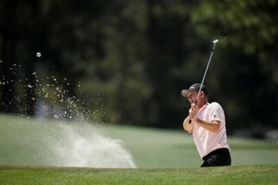 England's Justin Rose blasts a shot from a bunker at the 17th hole during the second round of the 90th Masters