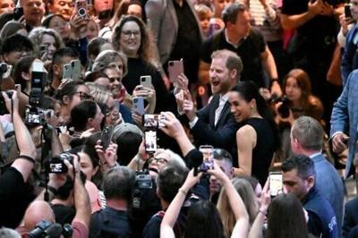 Britain's Prince Harry (C), Duke of Sussex, and his wife Meghan, the Duchess of Sussex, meet people at the Royal Children's Hospital in Melbourne on April 14, 2026.