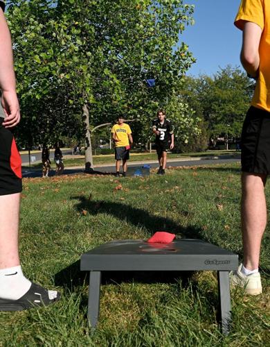 Owens Suba, back left, and Cayden Peters, back right, play cornhole