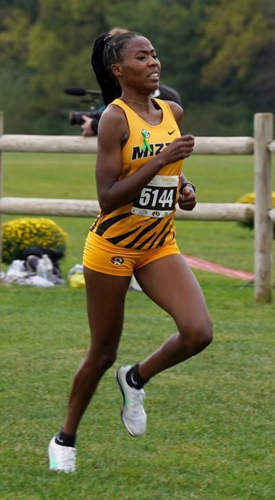 Monica Wanjiku runs towards the finish line during the Women’s Gold Invitational 6k race