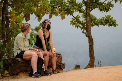 Tourists wear face masks as they visit Pai Canyon near Chiang Mai