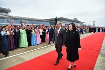 Chinese Foreign Minister Wang Yi (C) is welcomed by North Korean Foreign Minister Choe Son-hui (R) upon arriving on a two-day visit at Pyongyang International Airport on April 9, 2026.