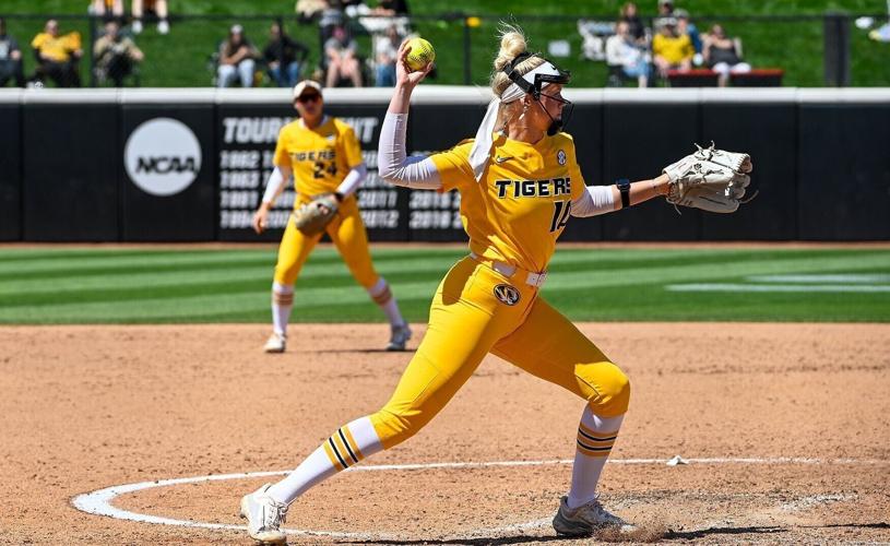Pitcher Marissa McCann (10) throws the ball to first base