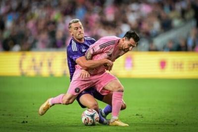 Inter Miami's Argentine forward, Lionel Messi, vies for the ball against Orlando City's Swedish defender Robin Jansson