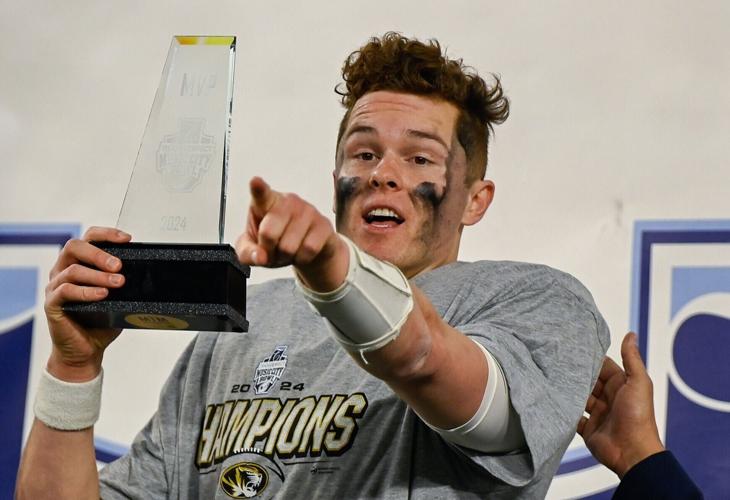 Mizzou quarterback Brady Cook points towards his teammates after being presented with the MVP (copy)