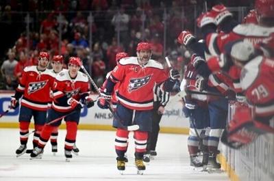 Alex Ovechkin of the Washington Capitals celebrates with teammates after scoring his 1,000th combined regular season and playoffs career goal in a home loss to Colorado