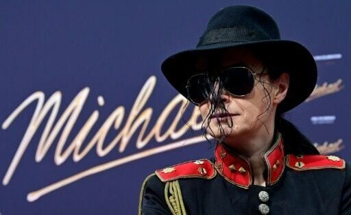 A Michael Jackson lookalike poses for photographers before the world premiere
