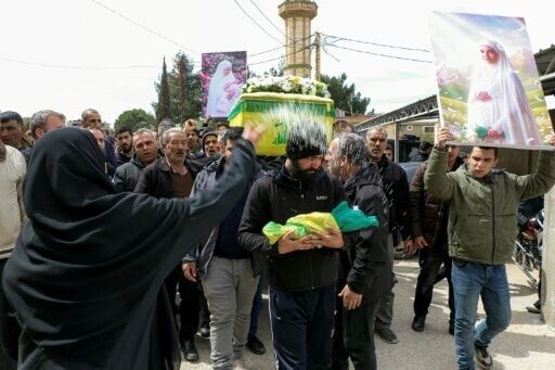 Mourners at the funeral of a woman, who was eight months pregnant with twins, killed the previous day in an airstrike on town of Bazaliyeh in Lebanon's eastern Bekaa valley