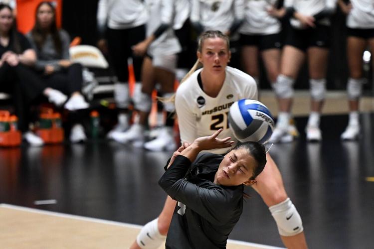 Mizzou senior libero Ainoah Cruz (4) gets hit by a spike